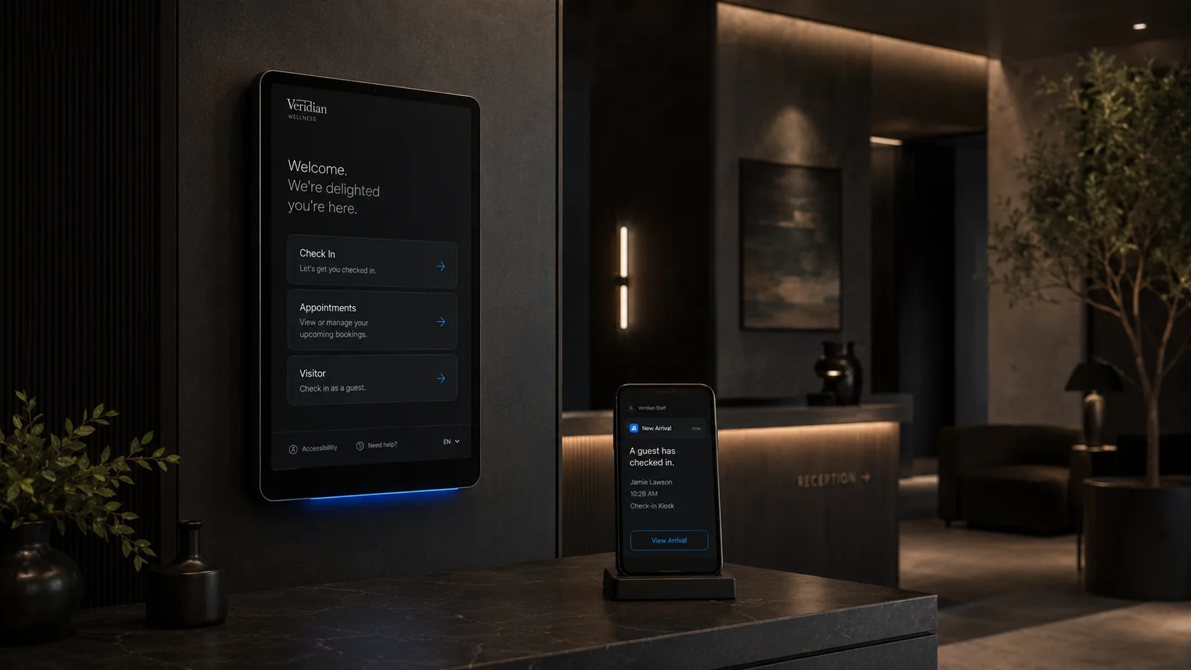 A wall-mounted kiosk and staff phone alert in a premium front office
